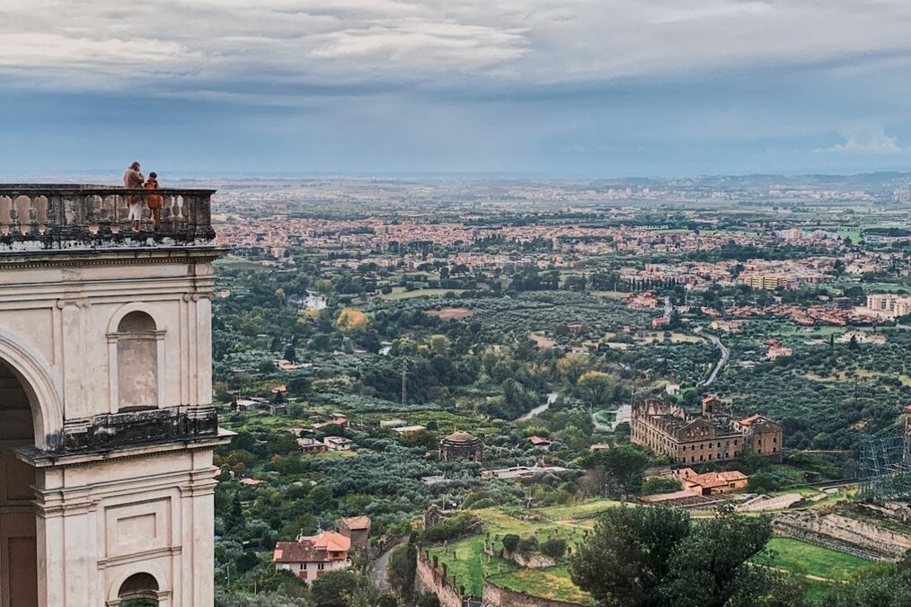 Two people overlooking a city in Italy